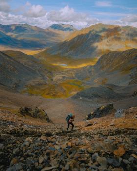 woman climbing up glissade pass in tombstone